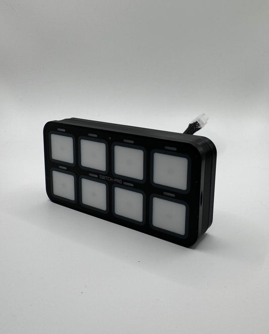 A black 3D printed mounting bracket installed on Switchpros panel