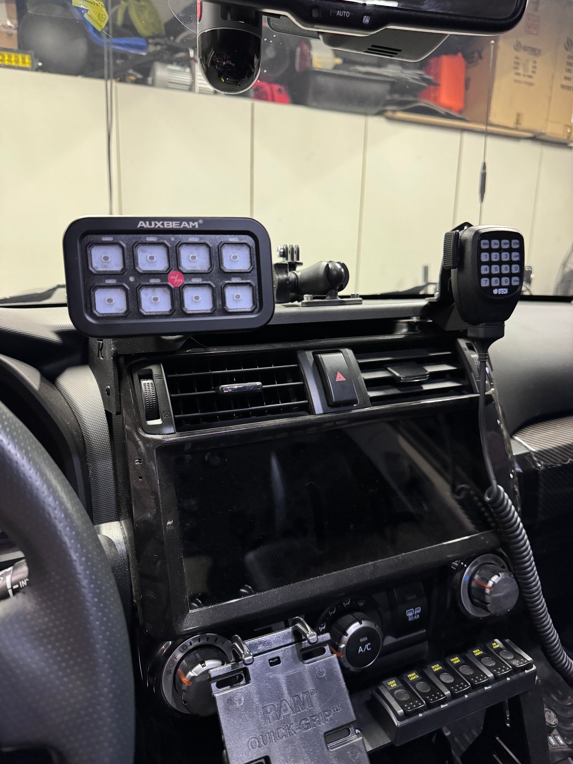 An Auxbeam switch panel mount, featuring an 8-gang switch panel installed in a vehicle's interior.