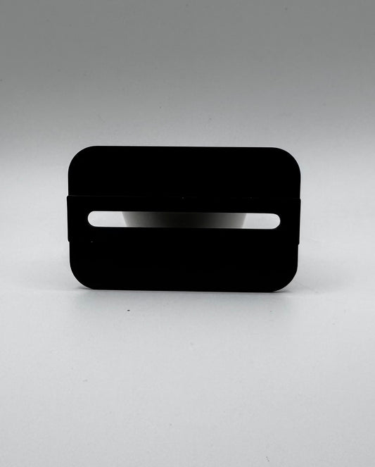 Black rectangular object with a white stripe on a gray background