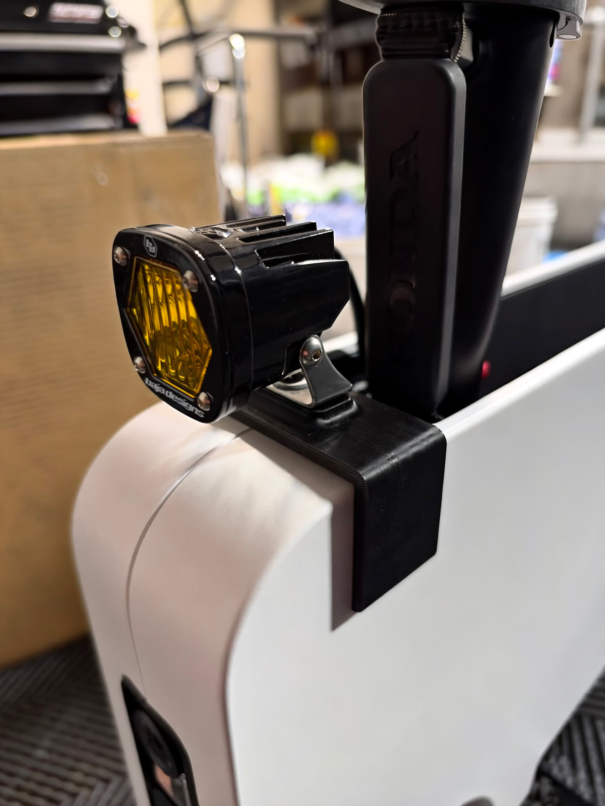 Side view of Baja Designs LED auxiliary light mounted to Obisan3D universal accessory bracket on Honda Motocompacto.