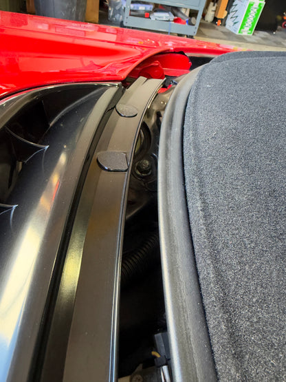 Two black Obisan3D NSX Engine Garnish Hole Covers installed in factory mounting holes on a first-generation Acura NSX.