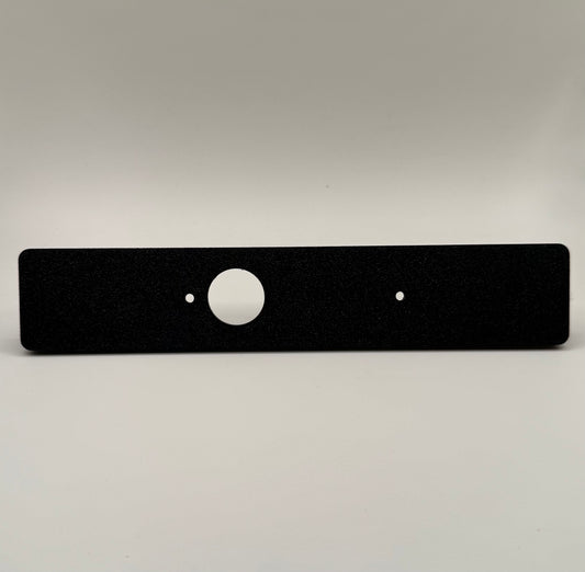 Black flat switch panel mount for LC250/Prado designed for Auxbeam, with a circular cutout in the center  against a white background.