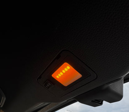 A switchable LED hatch light for Land Cruiser LC250/GX550 placed on a textured surface with the text 'LAND CRUISER' visible.