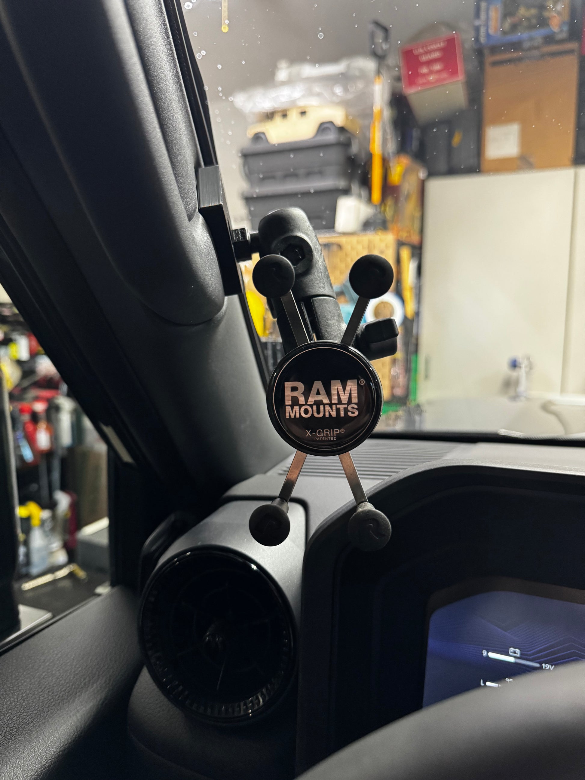 Phone mount on a car dashboard with RAM Mounts branding