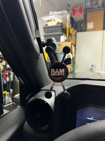 Phone mount on a car dashboard with RAM Mounts branding